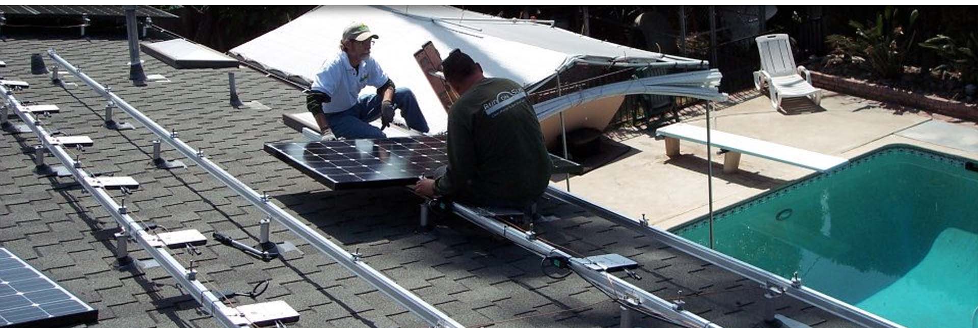 Technicians installing solar panels on a roof Technicians installing solar panels on a roof
