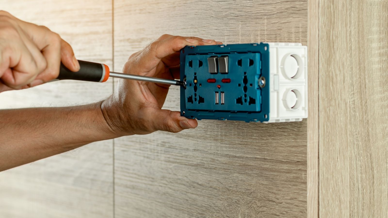 Electrician installing double electrical outlet and switch Electrician installing double electrical outlet and switch
