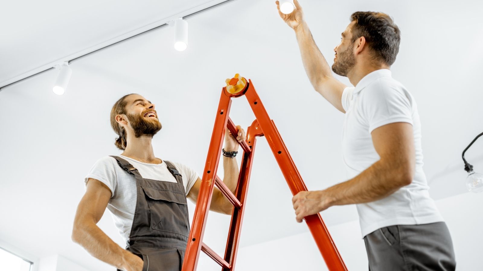 Electricians installing ceiling lights, indoor lighting Electricians installing ceiling lights, indoor lighting