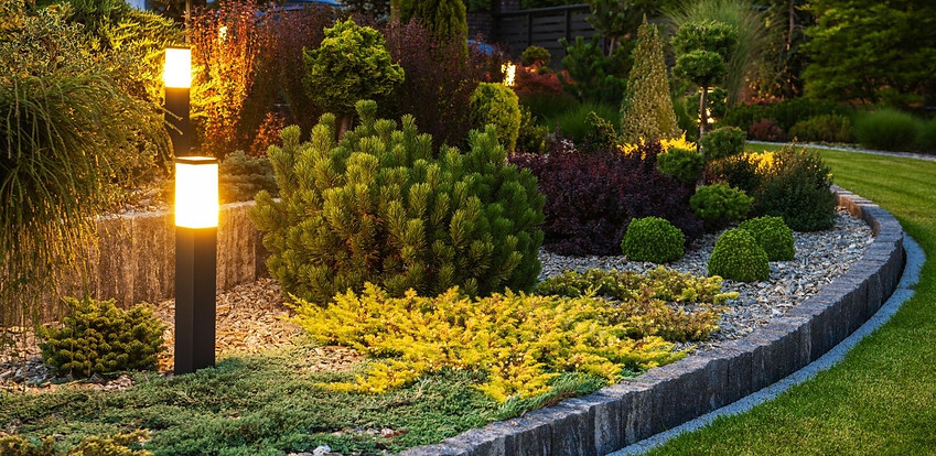 Landscaped garden with outdoor lighting at night Landscaped garden with outdoor lighting at night