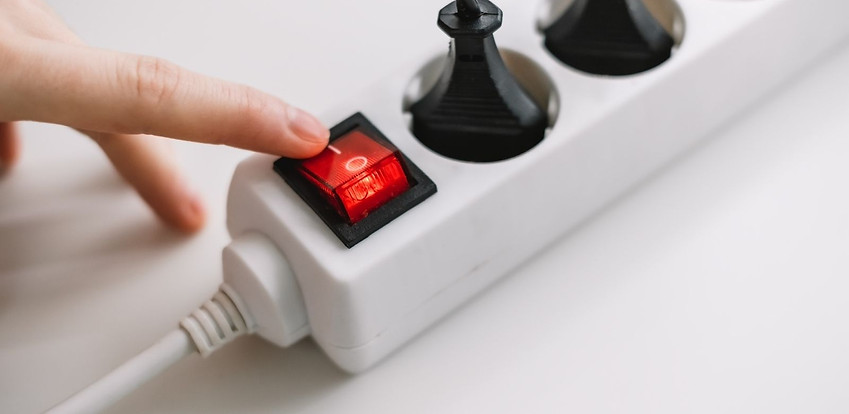 Hand turning off power strip Hand turning off power strip