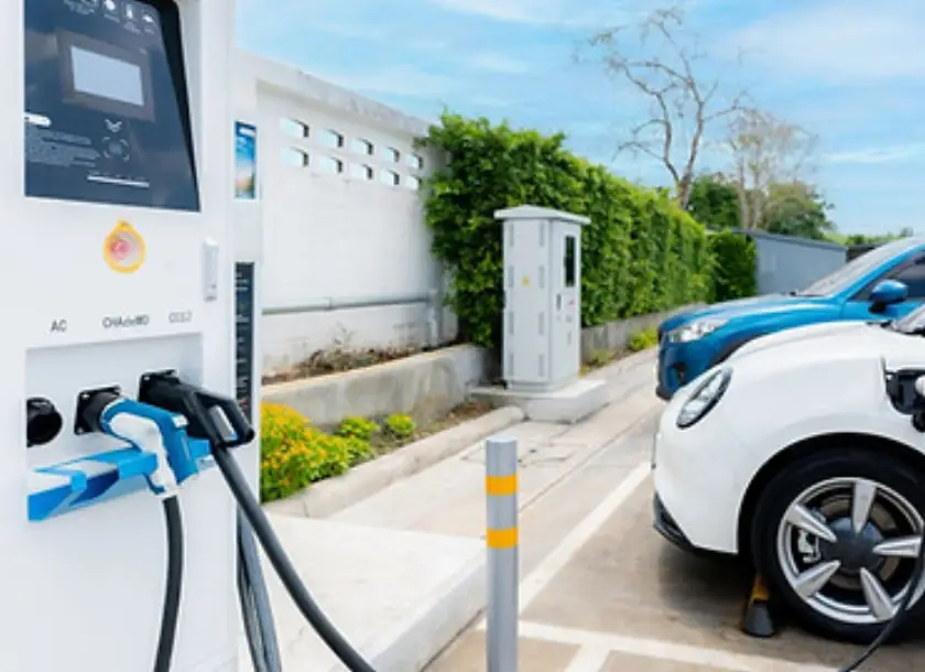 Electric vehicle charging station with two cars plugging in Electric vehicle charging station with two cars plugging in